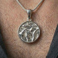 Load image into Gallery viewer, Polished silver mountain landscape pendant necklace worn on the neck, shown against the chest in a clean and elegant everyday wear composition.
