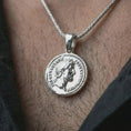Load image into Gallery viewer, Polished silver Roman coin pendant necklace worn on the neck, shown in a clean model shot with the classical emperor medallion centered for a refined antiquity-inspired look.
