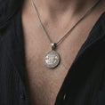 Load image into Gallery viewer, Oxidized Pope Innocent coin pendant necklace worn on the neck, styled in a dark lifestyle image that presents the antique papal medal as a bold historical and spiritual statement piece.
