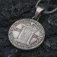 Load image into Gallery viewer, Oxidized Pope Innocent coin pendant necklace resting on black volcanic stone, featuring a papal portrait with Latin inscription in a detailed antique coin-style macro photograph.
