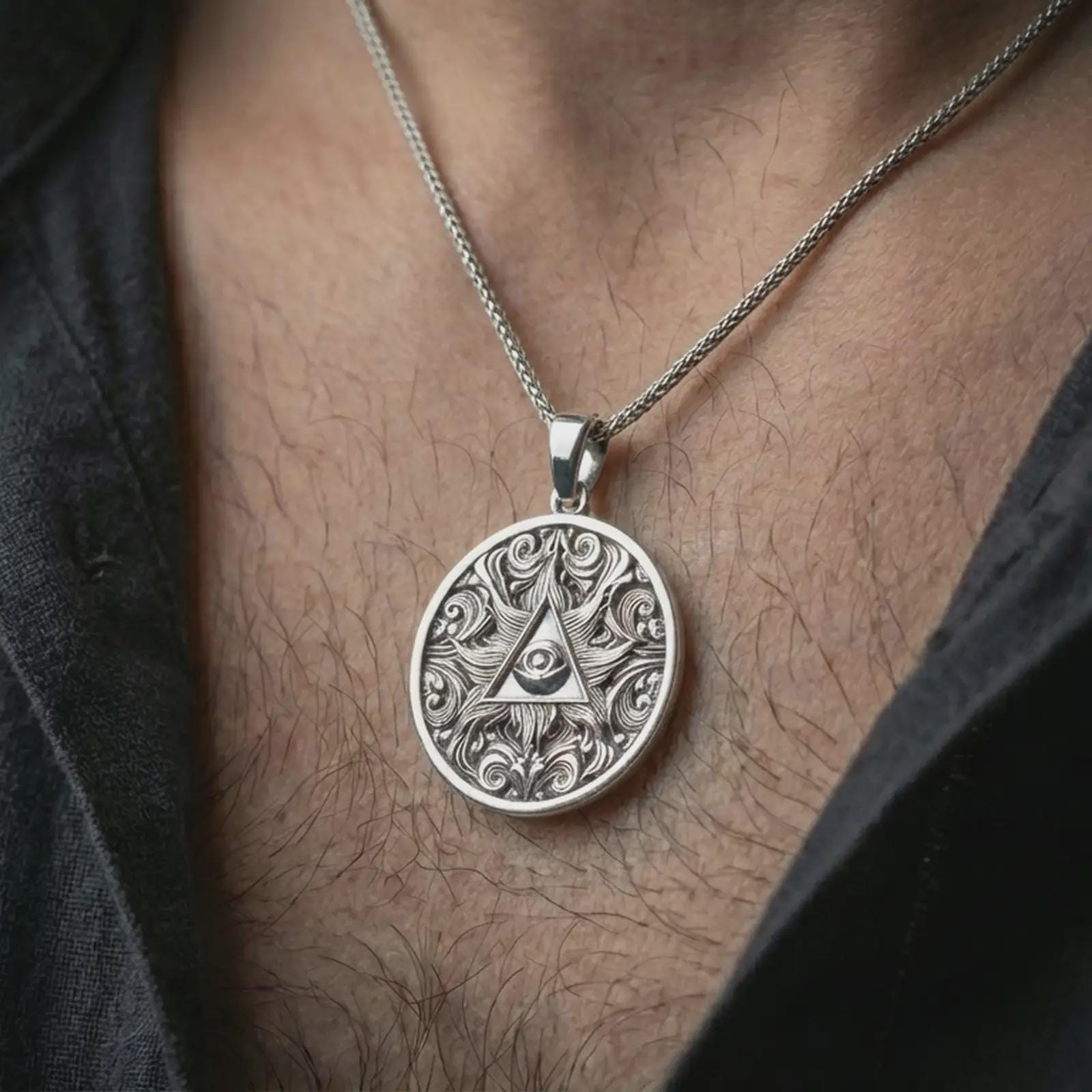 Polished silver Eye of Providence pendant necklace worn on the neck, shown against the chest in a clean and elegant everyday wear composition.