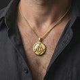 Load image into Gallery viewer, Gold plated Masonic emblem pendant necklace worn on the neck, captured on a human model in a premium dark-toned lifestyle frame.
