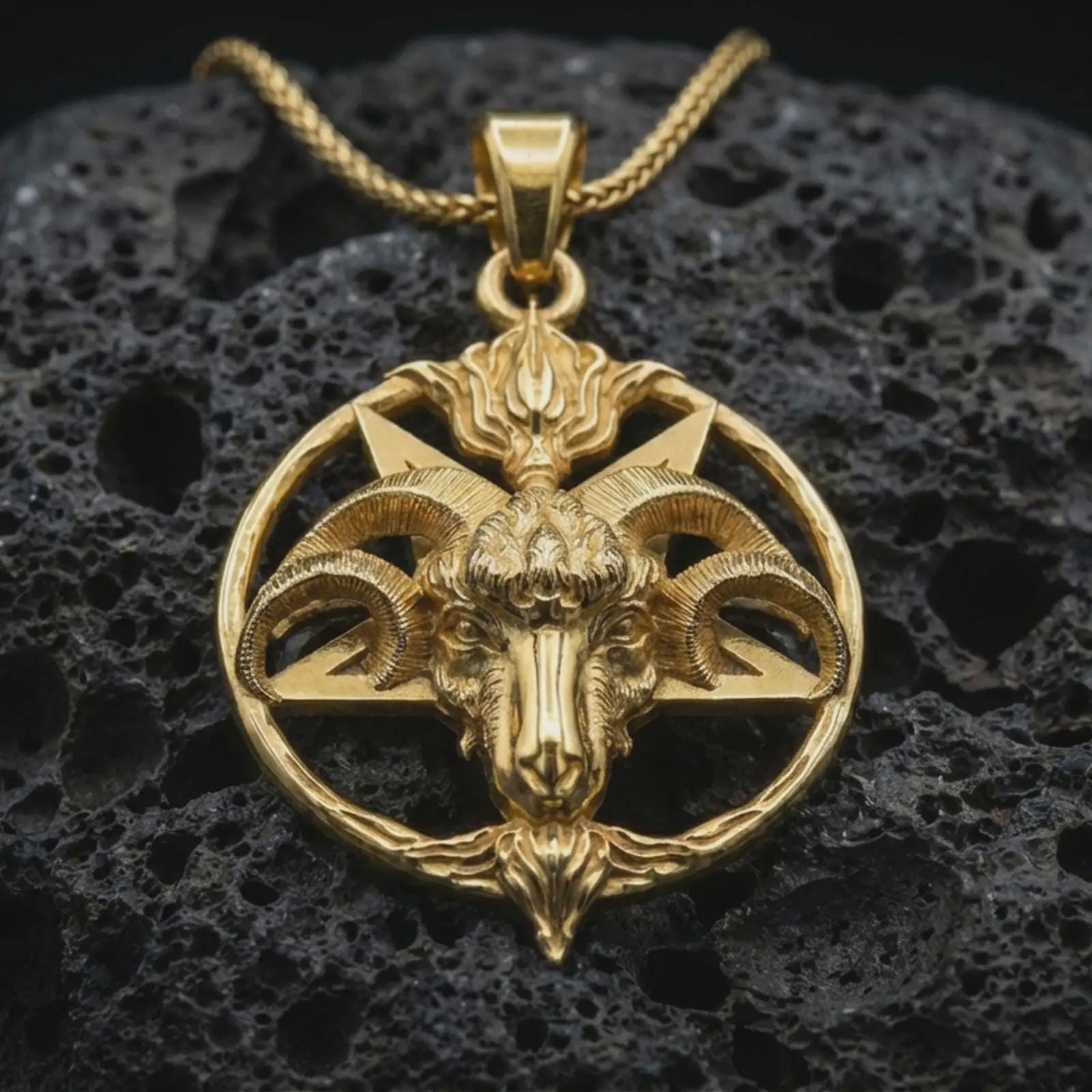 Gold plated Baphomet goat head pendant necklace presented on porous volcanic rock, highlighting the circular satanic symbol design in a luxurious close-up jewelry image.