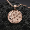 Load image into Gallery viewer, Rose gold plated moon and stars pendant necklace on dark volcanic rock, photographed in a detailed premium studio macro view.
