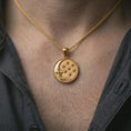 Load image into Gallery viewer, Gold plated moon and stars pendant necklace worn on the neck, captured on a human model in a premium dark-toned lifestyle frame.
