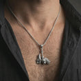 Load image into Gallery viewer, Polished silver paladin hammer pendant necklace worn on the neck, shown against the chest in a clean and dramatic everyday wear composition.
