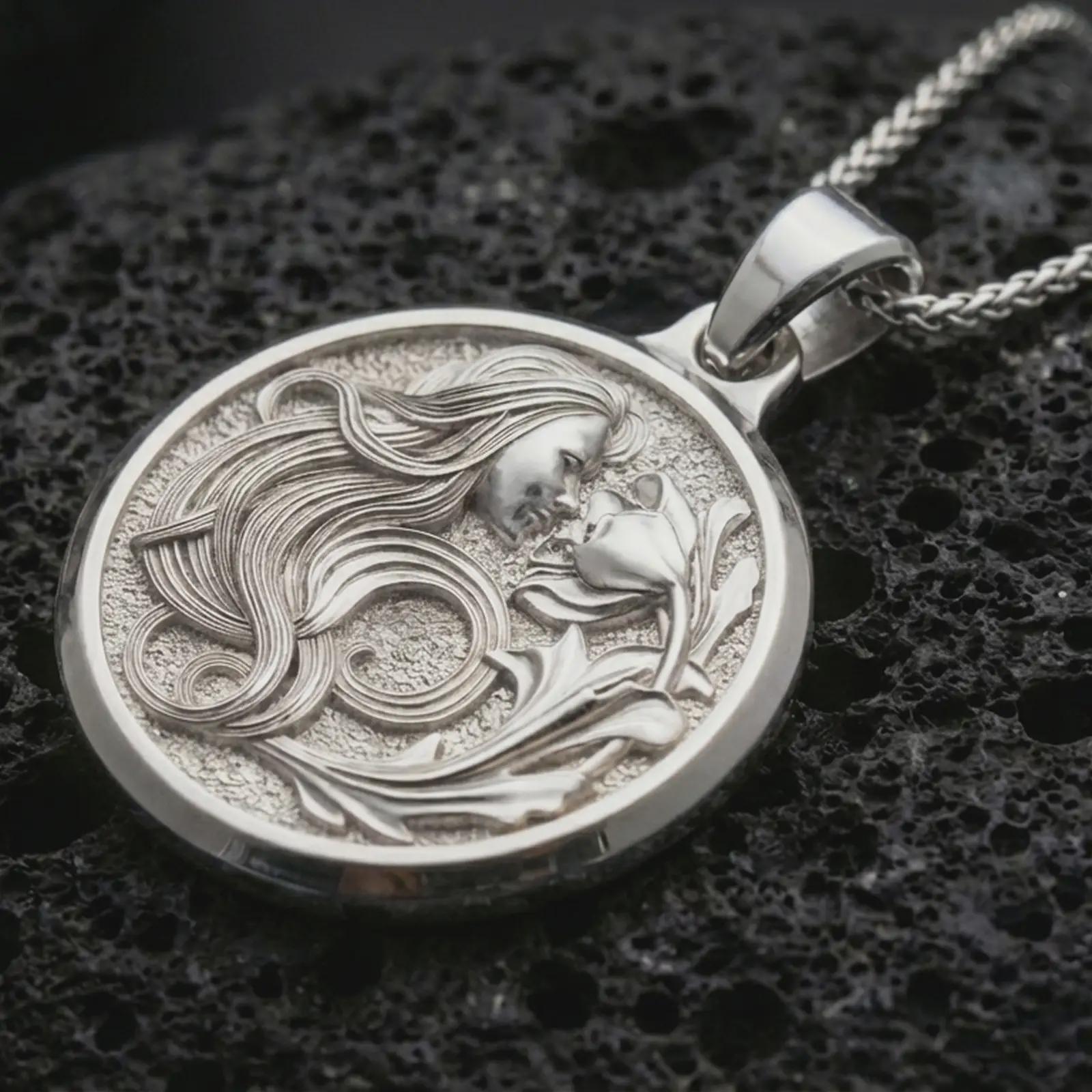 Polished silver Art Nouveau woman pendant necklace displayed on black volcanic rock, shown in a refined macro product shot with flowing hair and floral lily relief.