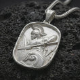 Load image into Gallery viewer, Polished silver Roman soldier pendant necklace displayed on black volcanic rock, shown in a refined macro product shot with detailed helmet, spear, shield, and wave relief.
