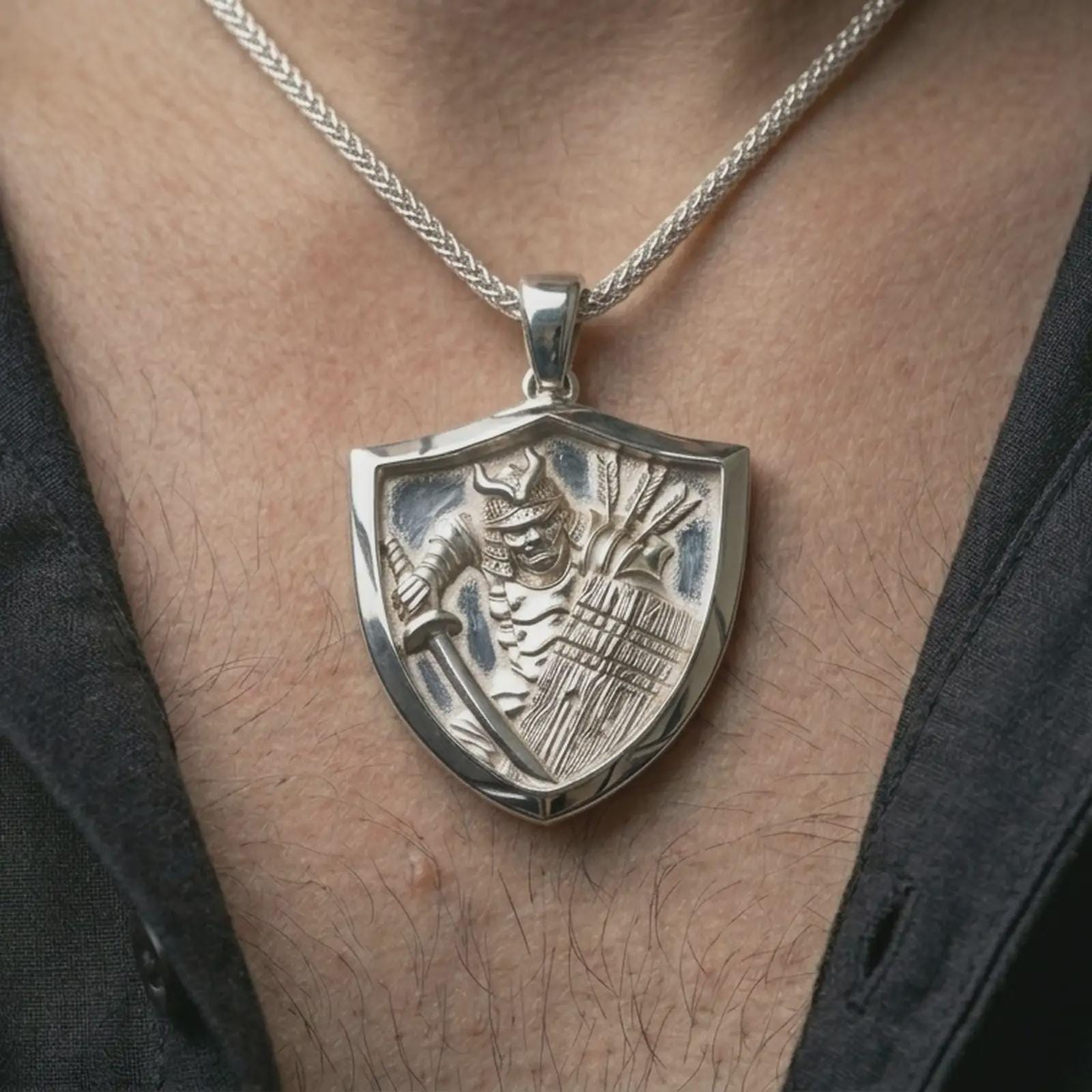 Polished silver samurai shield pendant necklace worn on the neck, shown against the chest in a clean and elegant everyday wear composition.