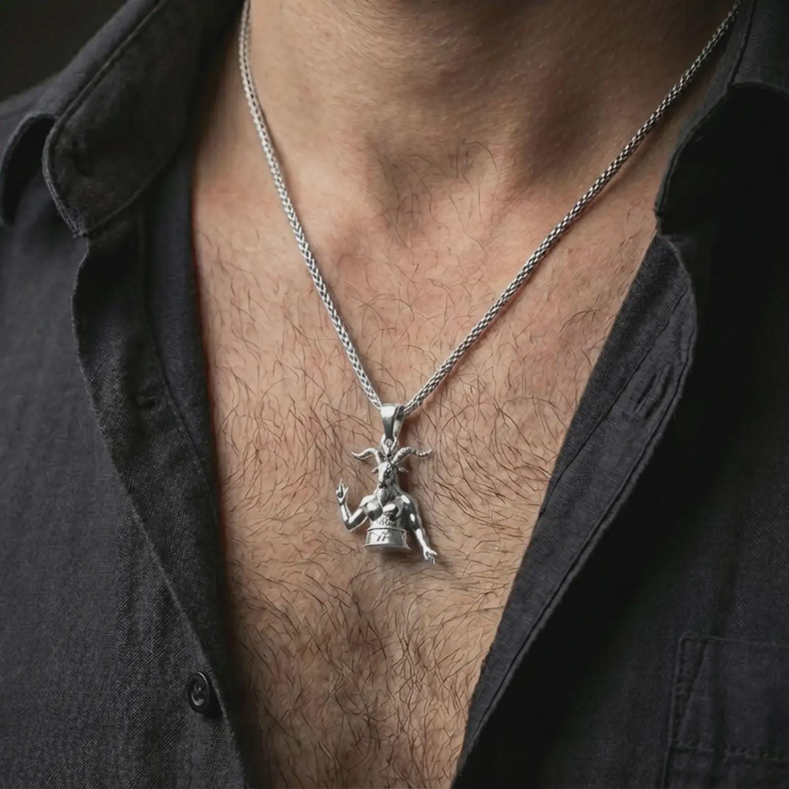 Polished silver Baphomet pendant necklace worn on the neck, shown against the chest in a clean and dramatic everyday wear composition.