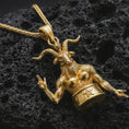 Load image into Gallery viewer, Gold plated Baphomet pendant necklace presented on porous volcanic rock, highlighting the gothic esoteric design in a luxurious close-up jewelry image.
