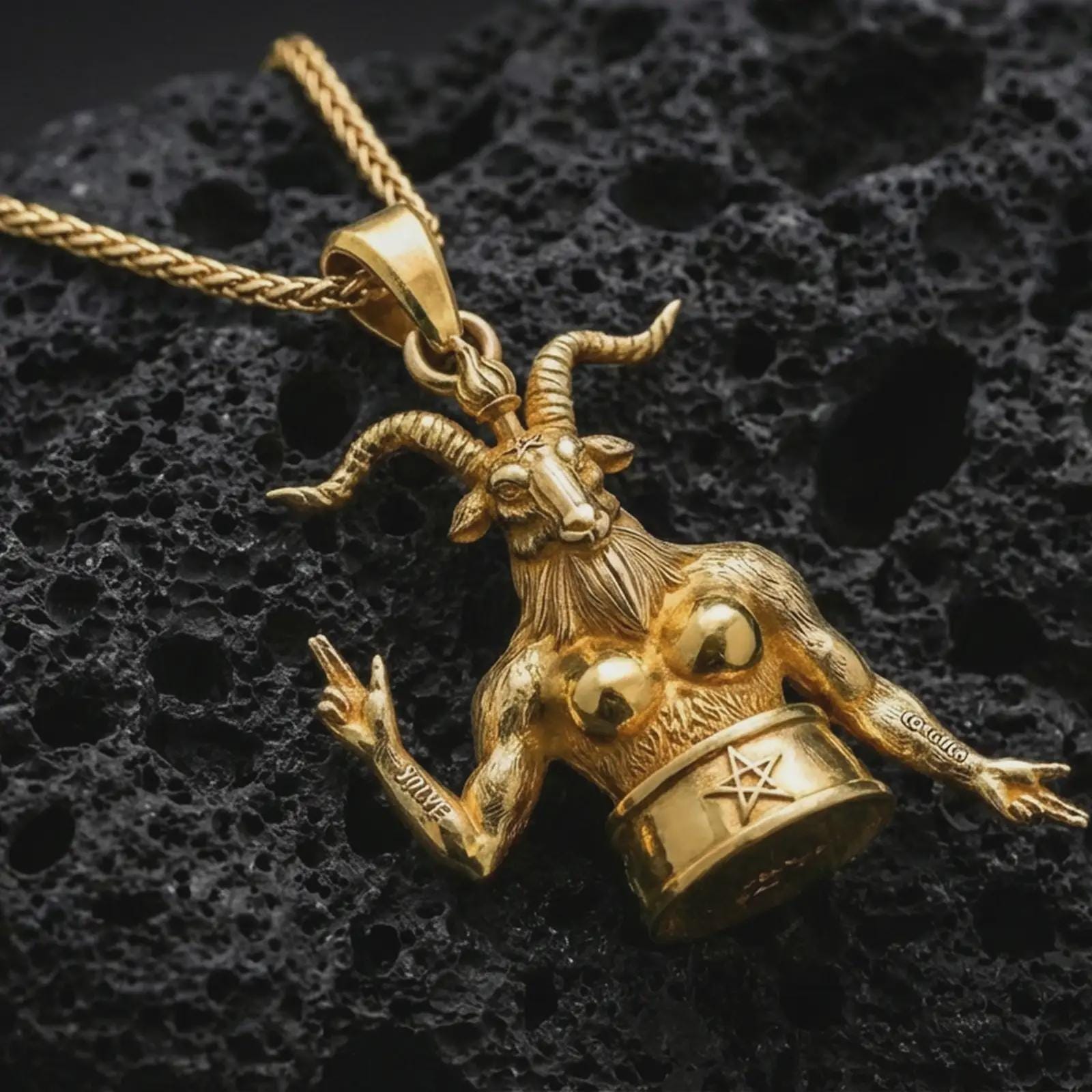 Gold plated Baphomet pendant necklace presented on porous volcanic rock, highlighting the gothic esoteric design in a luxurious close-up jewelry image.