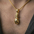 Load image into Gallery viewer, Gold plated origami pineapple pendant necklace worn on the neck, captured on a human model in a premium dark-toned lifestyle frame.
