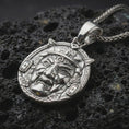 Load image into Gallery viewer, A polished 925 sterling silver Oni pendant on volcanic rock showing crisp relief details and clean shine on the raised edges.
