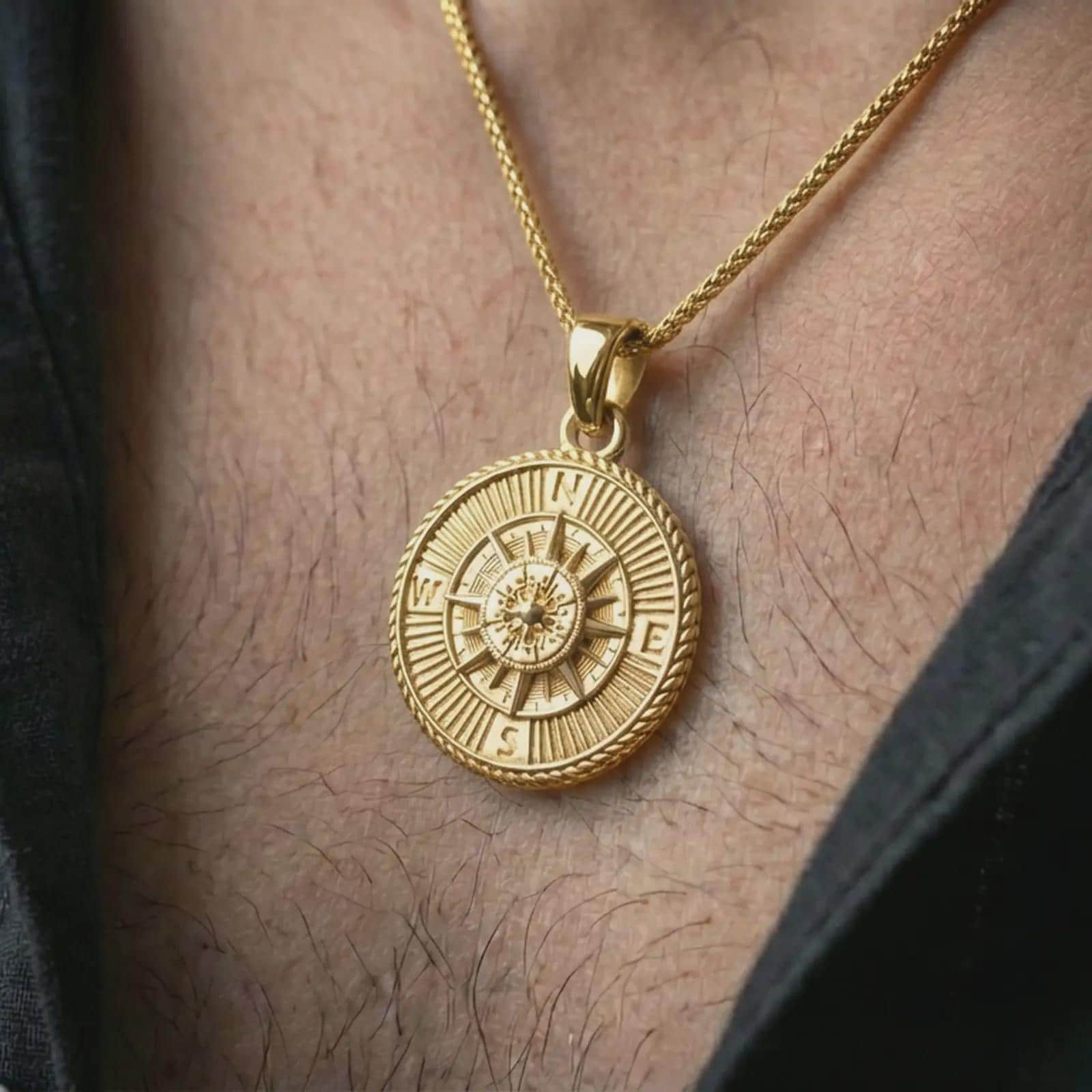 Gold plated steampunk compass pendant necklace worn on the neck, captured on a human model in a premium dark-toned lifestyle frame.