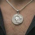 Load image into Gallery viewer, Polished silver Spartan helmet pendant necklace worn on the neck, shown against the chest in a clean and elegant everyday wear composition.
