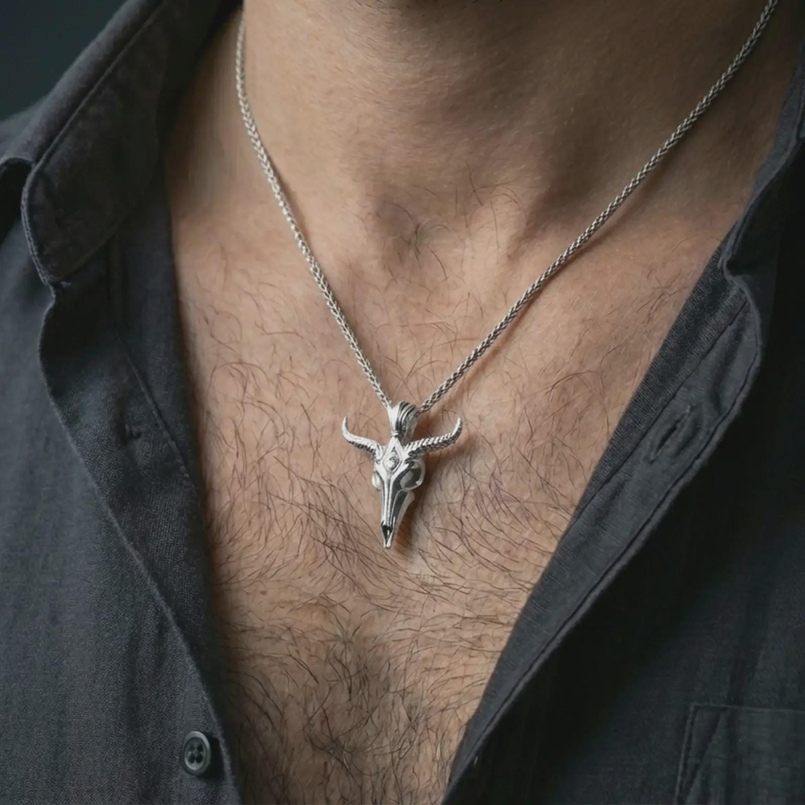 Polished silver Baphomet skull pendant necklace worn on the neck, shown against the chest in a clean and dramatic everyday wear composition.