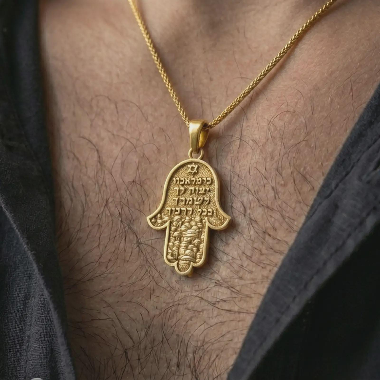 Gold plated Jerusalem Hamsa hand pendant necklace worn on the neck, captured on a human model in a premium dark-toned lifestyle frame.