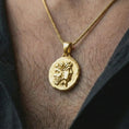 Load image into Gallery viewer, Gold plated Janus coin pendant necklace worn on the neck, captured in a premium lifestyle composition that highlights the Janus deity motif as a distinctive Roman heritage jewelry accent.

