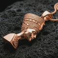 Load image into Gallery viewer, Rose gold plated Nefertiti pendant necklace on dark volcanic rock, photographed in a detailed premium studio macro view.
