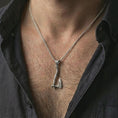 Load image into Gallery viewer, Polished silver battle axe pendant necklace worn on the neck, shown against the chest in a clean and striking everyday wear composition.
