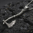 Load image into Gallery viewer, Sterling silver battle axe pendant necklace with an oxidized finish resting on textured volcanic rock, captured in a close-up premium studio composition.
