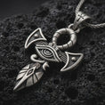 Load image into Gallery viewer, Sterling silver Eye of Horus ankh pendant necklace with an oxidized finish resting on textured volcanic rock, captured in a close-up premium studio composition.

