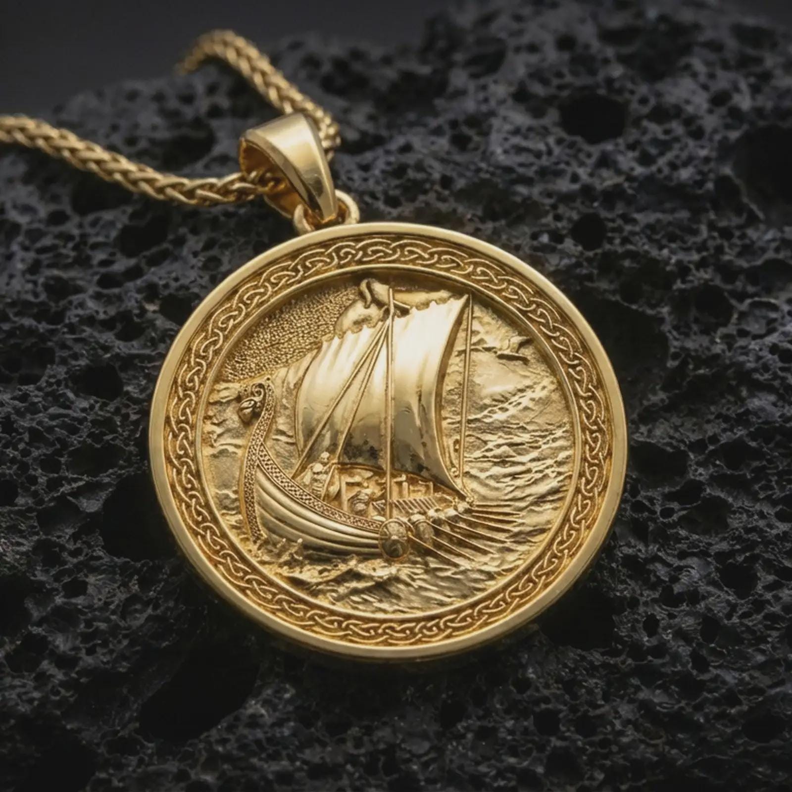 Gold plated Viking ship pendant necklace presented on porous volcanic rock, highlighting the Norse seafaring motif in a luxurious close-up jewelry image.