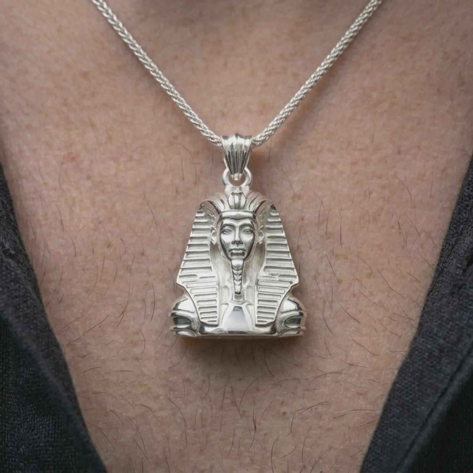 Polished silver Tutankhamun pendant necklace worn on the neck, shown against the chest in a clean and elegant everyday wear composition.