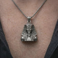 Load image into Gallery viewer, Oxidized Tutankhamun pendant necklace worn on the neck, styled in a dark lifestyle portrait with an open shirt and regal presentation.
