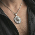Load image into Gallery viewer, Polished silver snarling wolf pendant necklace worn on the neck, shown against the chest in a clean and striking everyday wear composition.
