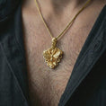 Load image into Gallery viewer, Gold plated floral bee pendant necklace worn on the neck, captured on a human model in a premium dark-toned lifestyle frame with refined botanical charm.
