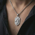 Load image into Gallery viewer, Polished silver wolf shield pendant necklace worn on the neck, shown against the chest in a clean and striking everyday wear composition.
