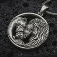 Load image into Gallery viewer, Sterling silver lion and bear family pendant necklace with an oxidized finish resting on textured volcanic rock, captured in a close-up premium studio composition.
