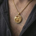 Load image into Gallery viewer, Gold plated lion and bear family pendant necklace worn on the neck, captured on a human model in a premium dark-toned lifestyle frame.
