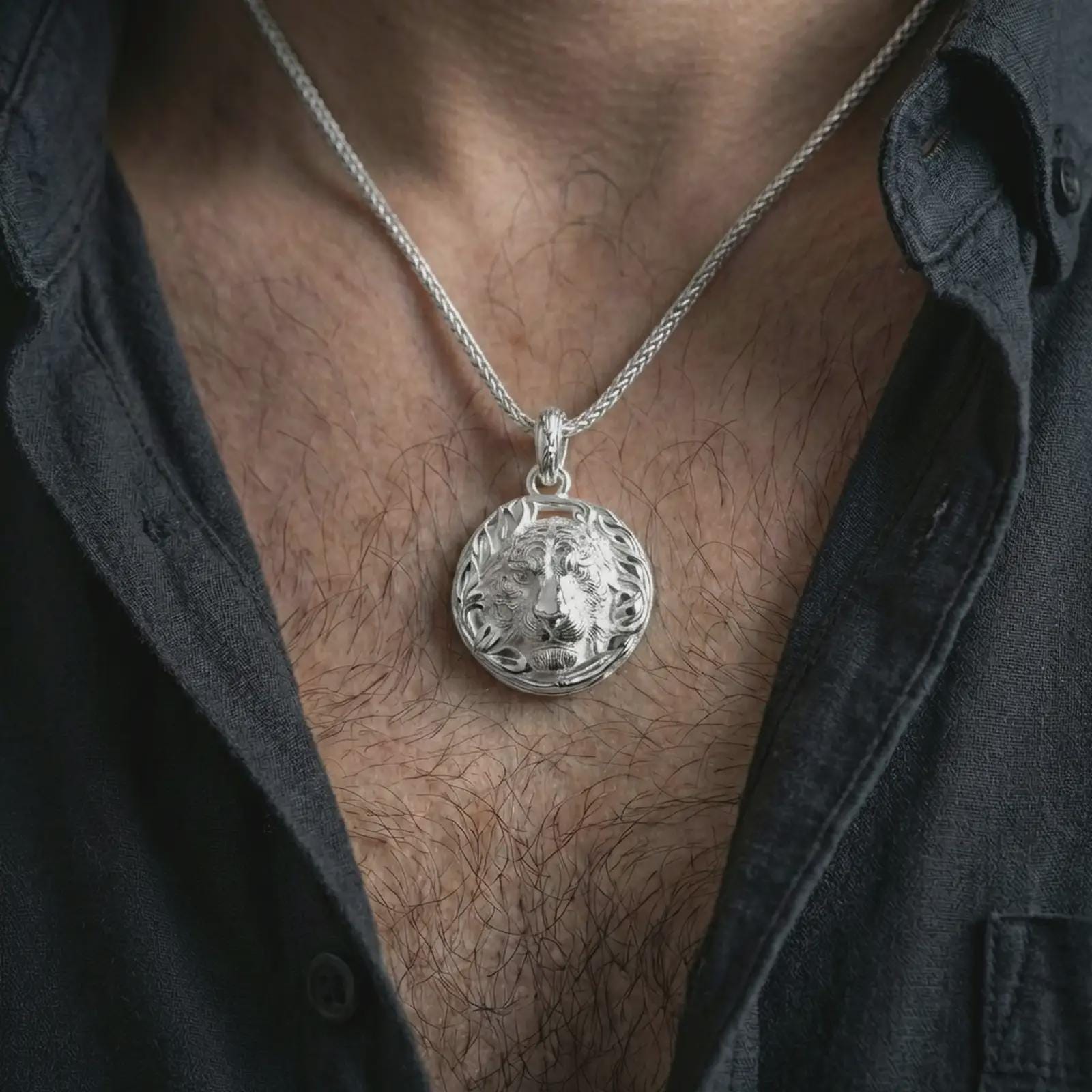 A polished sterling silver tiger pendant worn on the neck, clean everyday look with detailed relief and refined shine.