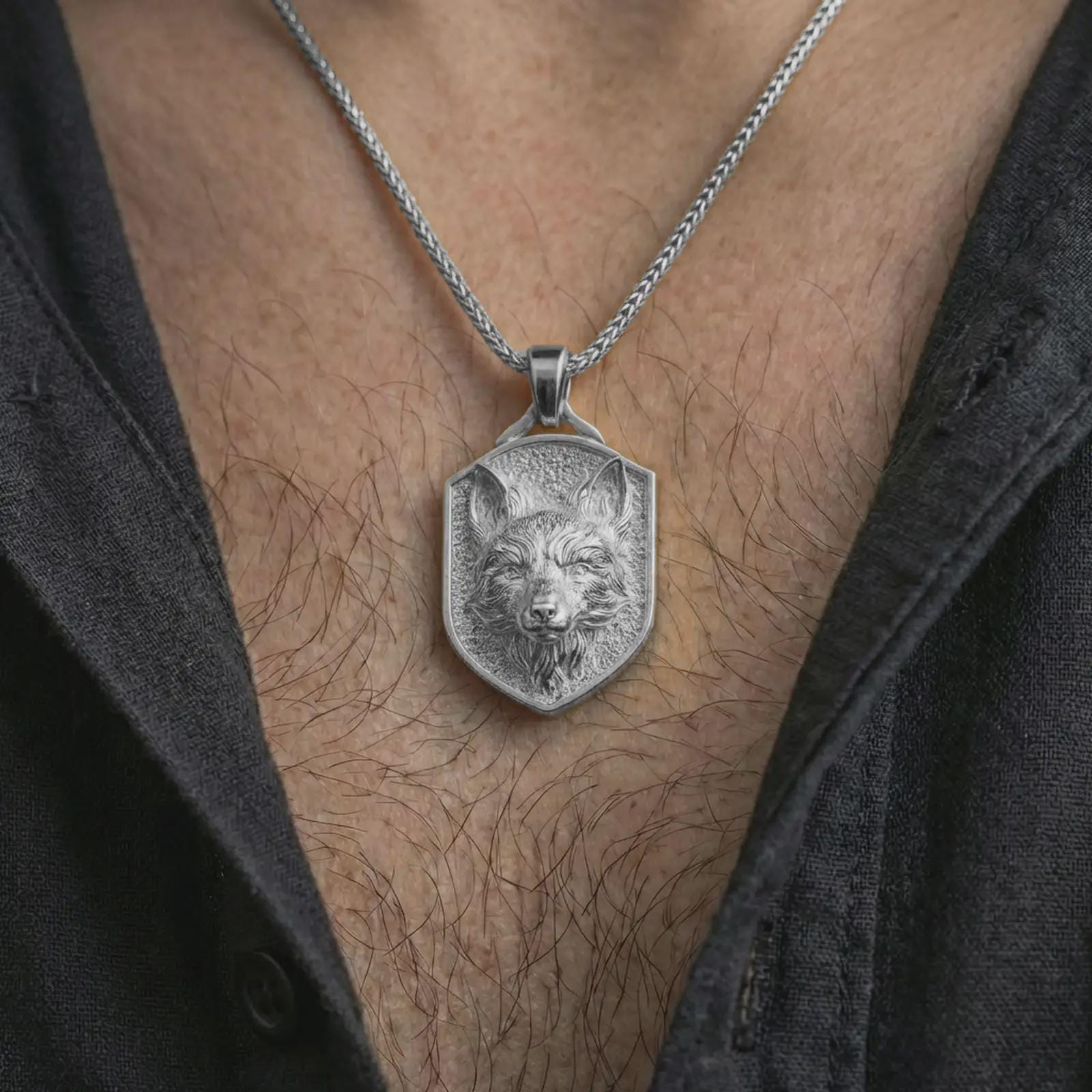 Polished silver fox shield pendant necklace worn on the neck, shown against the chest in a clean and striking everyday wear composition.