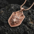 Load image into Gallery viewer, Rose gold plated fox shield pendant necklace on dark volcanic rock, photographed in a detailed premium studio macro view.
