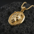 Load image into Gallery viewer, Gold plated lioness pendant necklace presented on porous volcanic rock, highlighting the fierce feminine predator design in a luxurious close-up jewelry image.
