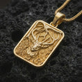 Load image into Gallery viewer, Gold plated stag forest pendant necklace presented on porous volcanic rock, highlighting the noble deer and enchanted woodland design in a luxurious close-up jewelry image.
