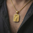 Load image into Gallery viewer, Gold plated stag forest pendant necklace worn on the neck, captured on a human model in a premium dark-toned lifestyle frame.
