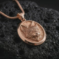Load image into Gallery viewer, Rose gold plated fox medallion pendant necklace on dark volcanic rock, photographed in a detailed premium studio macro view.
