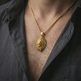 Load image into Gallery viewer, Gold plated lion head pendant necklace worn on the neck, captured on a human model in a premium dark-toned lifestyle frame.
