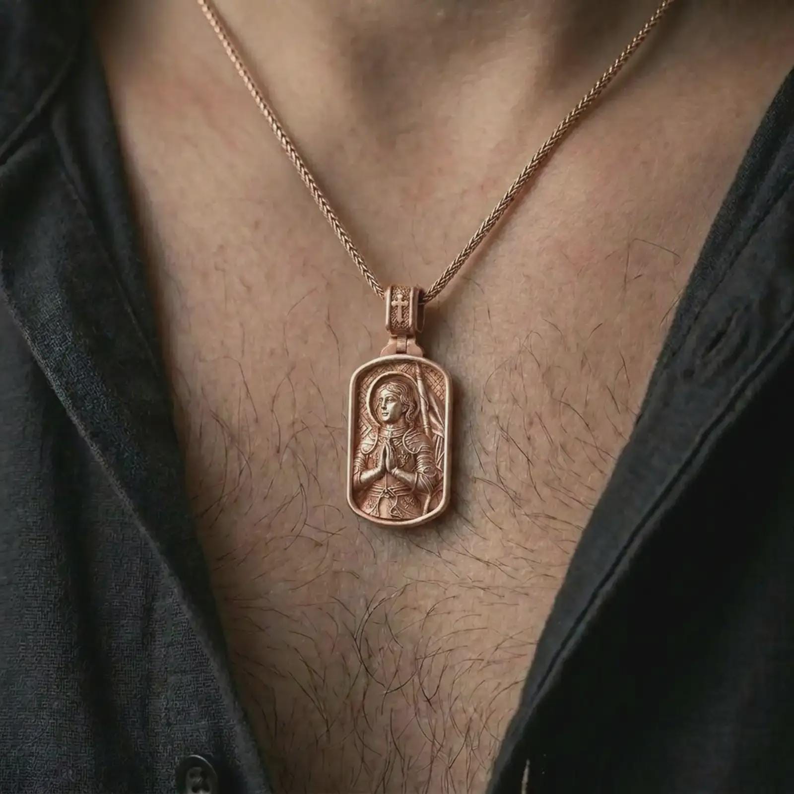 Rose gold plated Joan of Arc dog tag pendant necklace worn on the neck, presented in an elegant model photograph with a strong devotional aesthetic and symbolic presence.