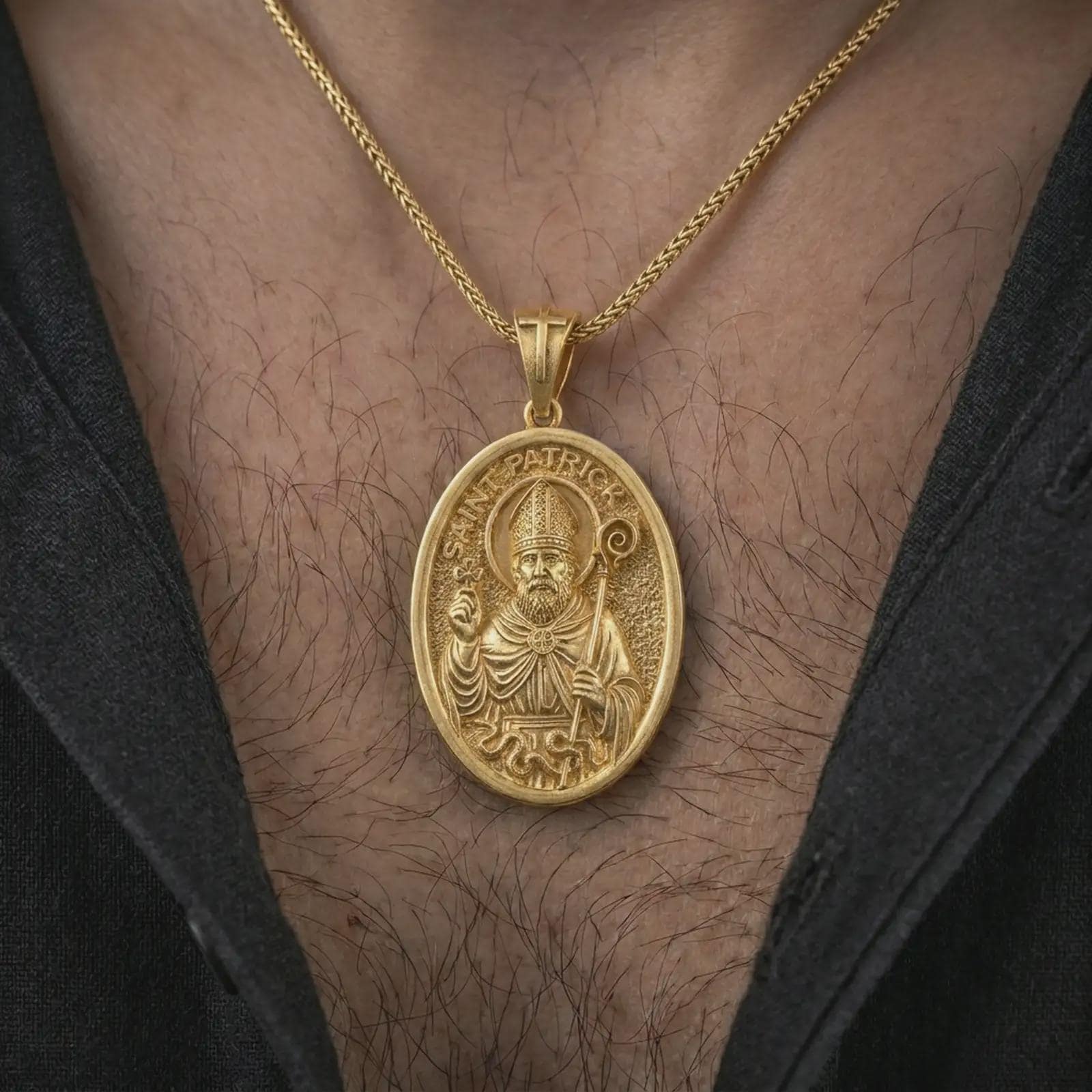 Gold plated Saint Patrick pendant necklace worn on the chest, premium lifestyle jewelry photo with the Irish patron saint medal centered on a spiga chain.