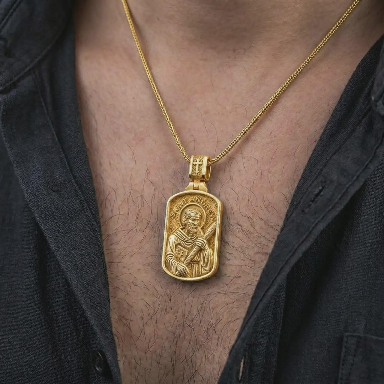 Gold plated Saint Andrew dog tag pendant necklace worn on the chest, premium lifestyle jewelry photo with the Saint Andrew dog tag medal centered on a spiga chain.