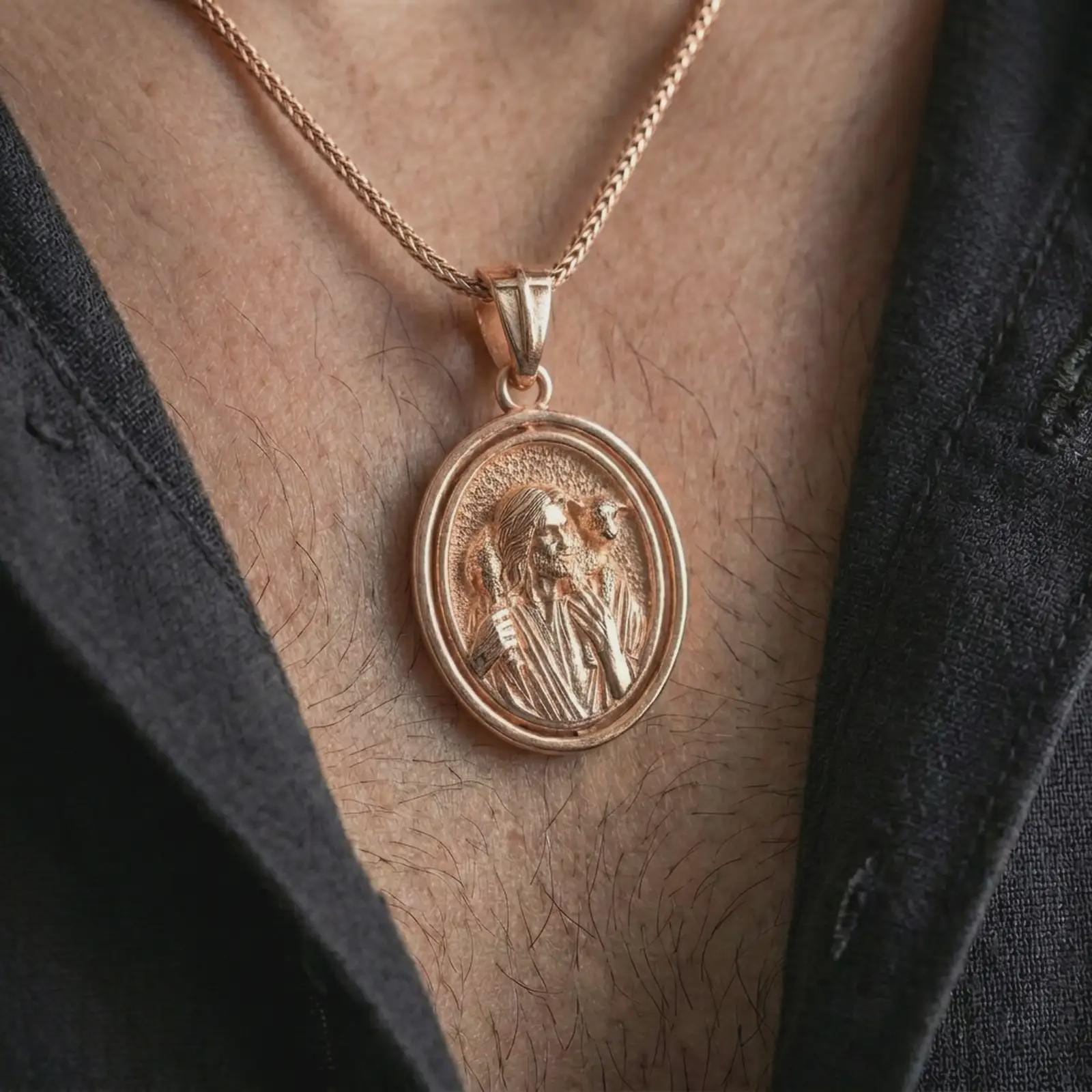 Rose gold plated spinning Good Shepherd pendant necklace worn on the chest, close-up lifestyle shot featuring the sacred shepherd design with warm rose gold tones.