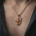 Load image into Gallery viewer, Rose gold plated kraken octopus shield pendant necklace worn on the neck, presented in a close-up lifestyle shot with a refined nautical aesthetic.
