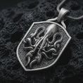 Load image into Gallery viewer, Sterling silver kraken octopus shield pendant necklace with an oxidized finish resting on textured volcanic rock, captured in a close-up premium studio composition.
