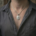 Load image into Gallery viewer, Polished silver roaring lion shield pendant necklace worn on the neck, shown against the chest in a clean and striking everyday wear composition.
